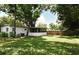 Large backyard with a privacy fence and mature trees, perfect for outdoor activities at 3519 Amigos Ave, Orlando, FL 32808