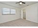 Cozy bedroom featuring carpet, a window, and an open closet with shelving at 3519 Amigos Ave, Orlando, FL 32808