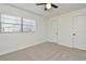 Simple bedroom with neutral carpet, a window, and a closet and door at 3519 Amigos Ave, Orlando, FL 32808
