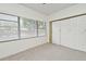 Carpeted bedroom with natural light from window and closet with paneled doors at 3519 Amigos Ave, Orlando, FL 32808