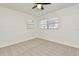 Bright bedroom featuring neutral carpet, a ceiling fan, and two windows for natural light at 3519 Amigos Ave, Orlando, FL 32808