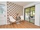 Cozy dining area features star pattern accent wall, modern table set, and glass doors to the outdoor patio at 3519 Amigos Ave, Orlando, FL 32808