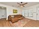 Comfortable living room featuring a plush leather sofa, stylish rug, and abundant natural light, perfect for relaxation at 3519 Amigos Ave, Orlando, FL 32808