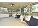 The screened patio with ceiling fan offers an outdoor living space for enjoying the surrounding yard at 3519 Amigos Ave, Orlando, FL 32808