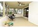 The screened patio with ceiling fan offers an outdoor living space for enjoying the surrounding yard at 3519 Amigos Ave, Orlando, FL 32808
