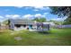 View of the large backyard and patio with outdoor seating and a trampoline for recreation at 3565 Sw Idlewild St, Dunnellon, FL 34431