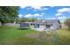 Expansive backyard featuring a trampoline, a jungle gym and access to the patio at 3565 Sw Idlewild St, Dunnellon, FL 34431