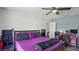 Bright bedroom featuring a comfortable bed, open closet, and workspace at 3565 Sw Idlewild St, Dunnellon, FL 34431