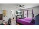 A spacious bedroom with a purple bed, television, and bathroom entrance at 3565 Sw Idlewild St, Dunnellon, FL 34431