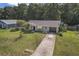 Charming single-story home featuring a well-maintained lawn and a long driveway leading to an attached garage at 3565 Sw Idlewild St, Dunnellon, FL 34431
