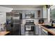 A modern kitchen features stainless steel appliances and grey cabinets and a dark sink at 3565 Sw Idlewild St, Dunnellon, FL 34431