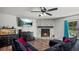 Living room with stone fireplace and dark furniture at 3565 Sw Idlewild St, Dunnellon, FL 34431