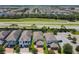 Expansive aerial view of neighborhood featuring manicured lawns, palm trees, and well-maintained roadways at 370 Pendant Ct, Kissimmee, FL 34747