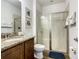 Bright bathroom with granite countertops, wood cabinets, and a sleek glass-enclosed shower at 370 Pendant Ct, Kissimmee, FL 34747