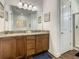 Bathroom featuring double sinks with granite counters and a large mirror at 370 Pendant Ct, Kissimmee, FL 34747
