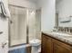Bathroom with walk-in shower, granite counters, wood vanity, and a toilet at 370 Pendant Ct, Kissimmee, FL 34747
