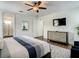 Bedroom with a king bed, TV, en suite bathroom, and stylish decor at 370 Pendant Ct, Kissimmee, FL 34747