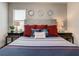 Comfortable bedroom featuring nautical decor, a decorative headboard, and matching end tables at 370 Pendant Ct, Kissimmee, FL 34747
