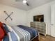 Bedroom featuring nautical decor, a dresser, and a ceiling fan at 370 Pendant Ct, Kissimmee, FL 34747