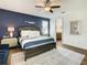 Bedroom with king bed, stylish decor, bedside tables and en suite bathroom at 370 Pendant Ct, Kissimmee, FL 34747