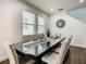 Bright dining room with a glass table, stylish chairs, and coastal decor at 370 Pendant Ct, Kissimmee, FL 34747