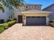 Charming two-story home featuring a paver driveway and a two-car garage at 370 Pendant Ct, Kissimmee, FL 34747
