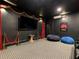 A stylish home theater room features red velvet curtains, tiered seating, and movie memorabilia for immersive entertainment at 370 Pendant Ct, Kissimmee, FL 34747
