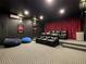 Home theater with multi-level seating, a large screen, and red velvet curtains at 370 Pendant Ct, Kissimmee, FL 34747