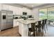 Well-equipped kitchen with a stainless steel refrigerator, granite countertops, and seating at the island at 370 Pendant Ct, Kissimmee, FL 34747