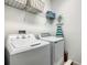 Bright laundry room with washer, dryer, shelving, and storage for efficient household tasks at 370 Pendant Ct, Kissimmee, FL 34747