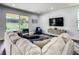 Comfortable living room featuring modern decor, and sliding doors to the pool and backyard at 370 Pendant Ct, Kissimmee, FL 34747