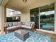 Inviting covered patio with comfortable seating, perfect for relaxing and enjoying the outdoor space at 370 Pendant Ct, Kissimmee, FL 34747