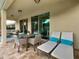 Covered outdoor patio featuring lounge furniture, table with seating and brick flooring at 370 Pendant Ct, Kissimmee, FL 34747