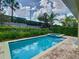 Sparkling swimming pool and spa with a patio, set against a backdrop of green landscaping and a blue sky at 370 Pendant Ct, Kissimmee, FL 34747