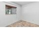 Neutral bedroom featuring a window with blinds and tan tile flooring, great for natural light at 380 Violet Dell Dr, Casselberry, FL 32707