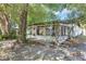 Backyard view with a sunroom, and mature trees provides a beautiful outdoor space and natural shade at 380 Violet Dell Dr, Casselberry, FL 32707