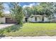 Charming single-story home with a brown garage door and mature landscaping in the front yard at 380 Violet Dell Dr, Casselberry, FL 32707
