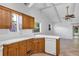 Kitchen with white countertops and wooden cabinets, open to a spacious living area at 380 Violet Dell Dr, Casselberry, FL 32707