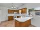 Traditional kitchen featuring wood cabinets, white countertops, and a view to the outside at 380 Violet Dell Dr, Casselberry, FL 32707