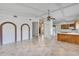 Open living room with tile floors, brick archways, and easy access to the kitchen at 380 Violet Dell Dr, Casselberry, FL 32707