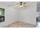 Empty living room features tile flooring, neutral paint, and a ceiling fan at 380 Violet Dell Dr, Casselberry, FL 32707