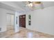 Spacious empty living room features neutral paint, tile flooring, and double front doors at 380 Violet Dell Dr, Casselberry, FL 32707