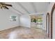 Bright living room with exposed ceiling beams and sliding glass doors to a screened porch at 380 Violet Dell Dr, Casselberry, FL 32707