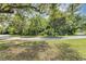 Quiet street view of the home and surrounding area showing established trees, landscaping at 380 Violet Dell Dr, Casselberry, FL 32707