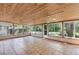 Large enclosed sunroom features a wooden ceiling with dual ceiling fans, and sliding windows at 380 Violet Dell Dr, Casselberry, FL 32707