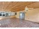 Spacious sunroom with wood ceilings, tile flooring, and sliding door to patio, with ceiling fans at 380 Violet Dell Dr, Casselberry, FL 32707