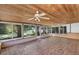 Enclosed sunroom featuring wood ceiling with dual ceiling fans, and sliding windows for maximum natural light at 380 Violet Dell Dr, Casselberry, FL 32707