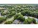 An aerial view of a neighborhood near a lake, highlighting lush greenery and well-maintained streets at 4018 August Ct, Casselberry, FL 32707