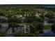 Aerial view of a neighborhood with tree-lined streets and nearby lake at 4018 August Ct, Casselberry, FL 32707