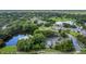 Beautiful community aerial view features lush landscaping, a pond, golf course and various neighborhood amenities at 4018 August Ct, Casselberry, FL 32707